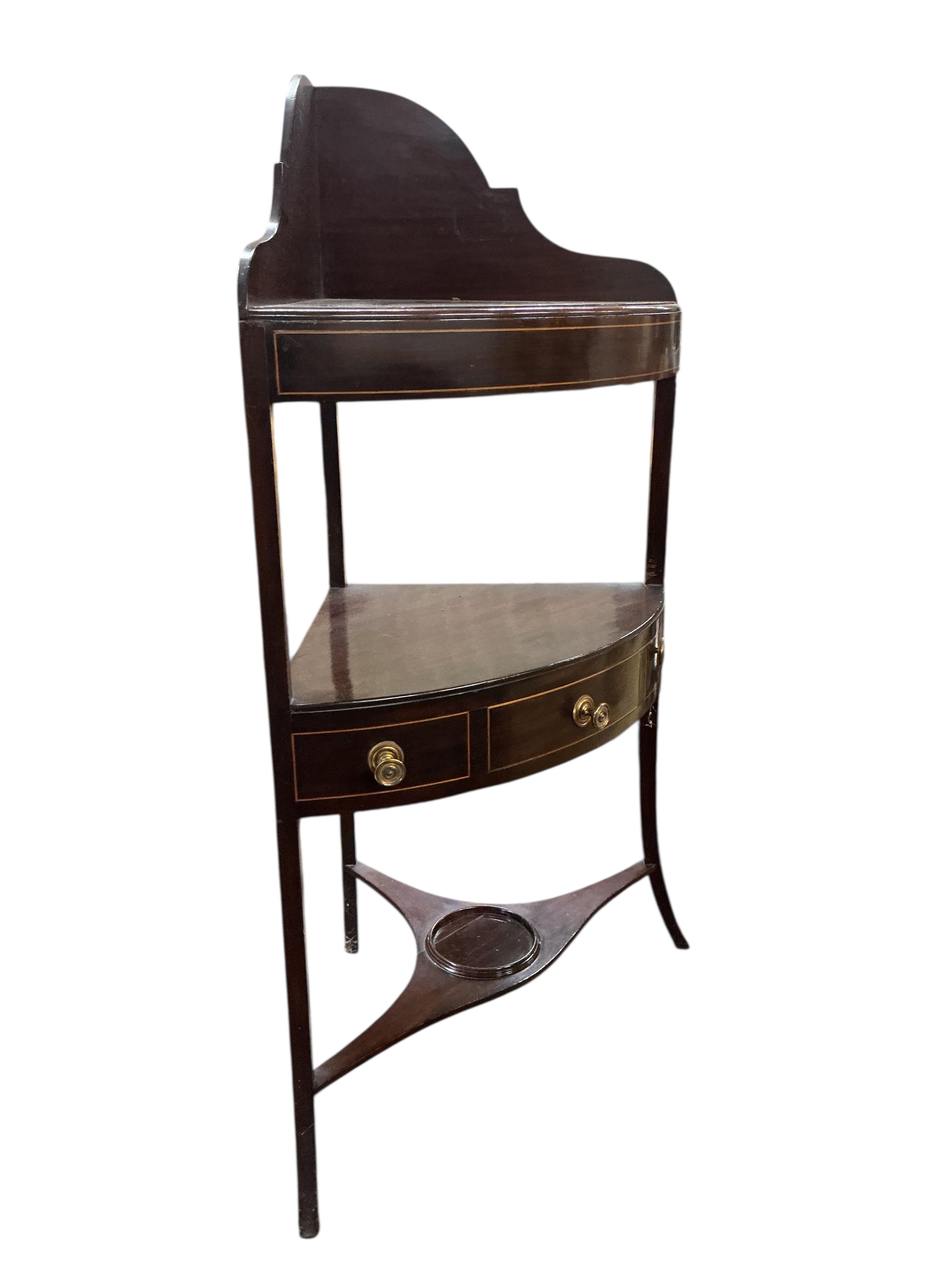A George III inlaid mahogany bow fronted corner washstand, width 56cm, depth 37cm, height 103cm